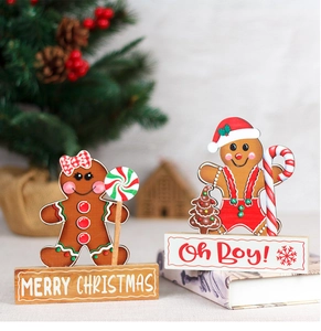 Close-up of wooden gingerbread man desk ornaments with Merry Christmas lettering