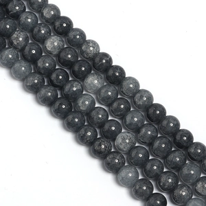 Macro detail of dark grey cracked glass round beads for DIY jewelry and accessory making