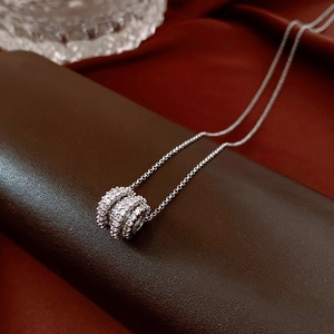 Detailed macro shot of a S925 sterling silver cylinder pendant with micro-set zircons