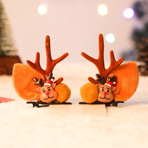 Detail of orange plush reindeer antler hair clips with cute cartoon deer resin patches