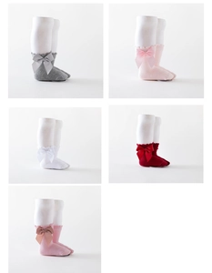 Detail of baby princess socks featuring large satin bows and ruffled lettuce trim
