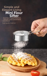 Action shot of handheld stainless steel flour sifter dusting fine sugar over fresh waffles