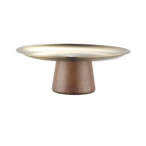Elegant gold metal fruit tray with a minimalist tapered brown wooden pedestal base