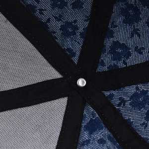 Detail view of denim floral baseball cap interior with reinforced seams and metal rivet