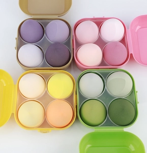 Set of four ultra-soft makeup sponges in various shapes inside clear storage boxes