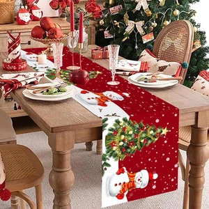Christmas table runner with snowman and tree patterns on a wooden dining table