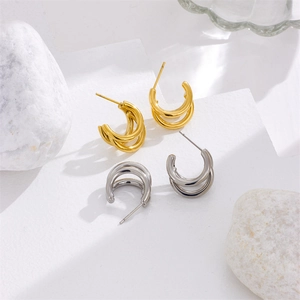Three-layer stacked C-shape hoop earrings in polished gold and silver metallic finish