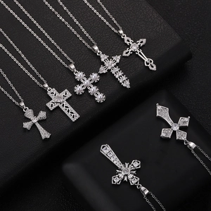 Elegant variety of copper zircon cross necklaces with pearls on black leather display