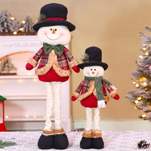 Detail of plush Christmas snowmen with red plaid coats and extendable legs in festive decor