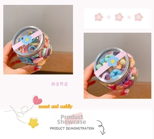 Detailed view of colorful macaron hair ties in a clear jar with a decorative lid