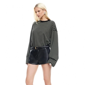 Full view of women's olive green and black striped long-sleeve t-shirt with leather shorts