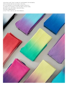 Flat lay view of various colorful gradient ribbed yoga socks in a neat grid arrangement