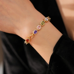 Detail of vintage gold bracelet featuring colorful oval-cut cubic zirconia gemstones