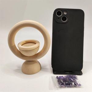 Vertical wooden diffuser ring shown next to smartphone and purple crystals for scale