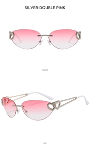 Detail of silver frameless Y2K sunglasses with heart-shaped cutouts and pink gradient lenses