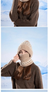 Close-up of winter knit beanie with warm fleece lining and large pompom in light brown