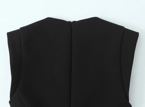 Close-up of the invisible zipper and shoulder stitching on a black jumpsuit
