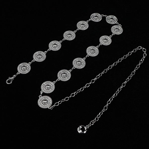 Detail of silver metal waist chain with circular patterns and lobster clasp closure