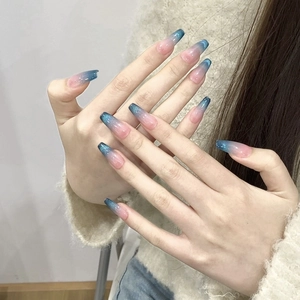 Detail of pink and blue gradient cat-eye press-on nails in long coffin shape with glitter