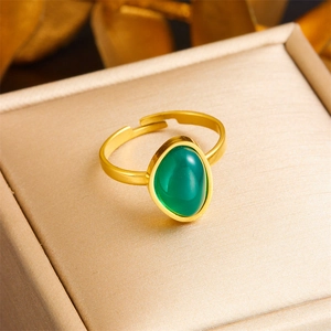 Vintage gold adjustable stainless steel ring with an oval emerald green gemstone