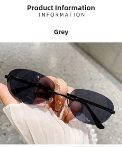 Detail of rimless oval sunglasses with grey lenses and slim metal temples in hand