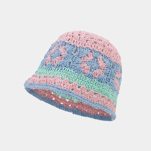 Detail of hand-crocheted hollow floral pattern on a colorful cotton bucket hat