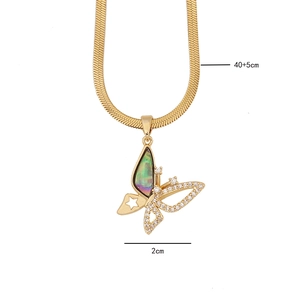 Detail of gold butterfly necklace with abalone shell and pavé crystal setting