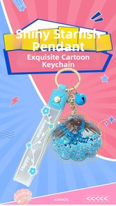 Detail of starfish drift bottle keychain with blue sand glitter and golden ring