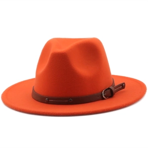 Detailed close-up of the bright orange fedora hat with a buckled leather band decoration