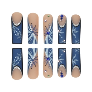 Press on nails with long coffin shape featuring blue snowflakes and glitter rhinestones