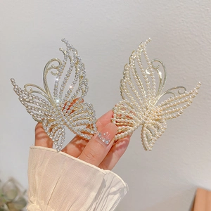 Elegant butterfly hair claws set in silver rhinestone and gold pearl metal finish