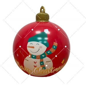Close-up of red inflatable Christmas ball with snowman pattern and golden Merry Christmas text