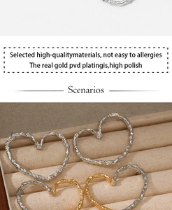 Detailed view of large heart earrings featuring a unique hammered texture and PVD gold plating