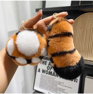 Detailed plush tiger tail keychain with orange and black stripes and gold hardware