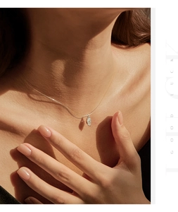 Close-up of marquise-cut moissanite pendant on invisible fishline silver chain