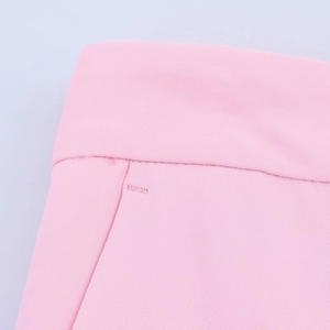 Close-up of pink twill suit fabric with detailed stitching on the waist and pocket area