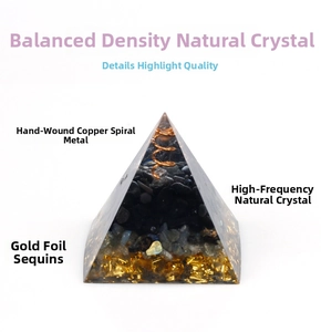 Close-up of Orgone pyramid with copper spiral, natural crystal, and gold foil detail
