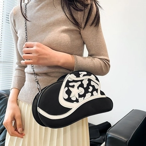 Unique cow print cowboy hat crossbody bag with star detail and silver chain strap