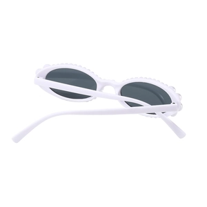 Vintage oval sunglasses with white frames and pearl accents on a clean white background
