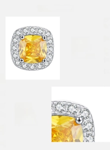Macro detail of S925 silver halo earrings with cushion cut yellow cubic zirconia stones