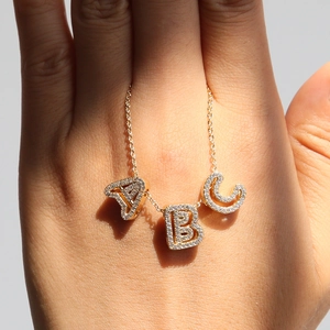 Handheld 18k gold plated brass necklace with sparkling A, B, and C zircon initial pendants
