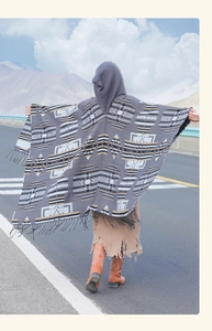Back view of hooded gray bohemian shawl with geometric ethnic patterns and fringe detail