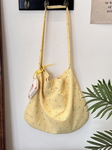 Fresh yellow hobo bag with colorful polka dots, plaid pattern and bird charm accessory