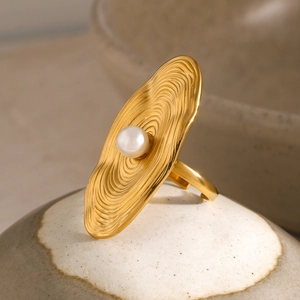 Artistic gold 18K plated ring with wavy concentric textures and a white pearl center
