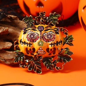 Halloween pumpkin witch broom brooch with colorful rhinestones on orange background
