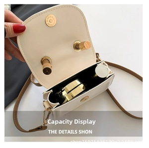 Detailed interior view of beige mini bag showing storage for lipstick and gold magnetic clasp