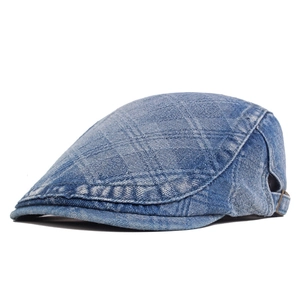 Close-up of washed denim ivy cap featuring diamond texture and metal side buckle