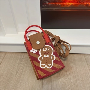 Detail of knitted Christmas mini bag with gingerbread man pattern and red round handle
