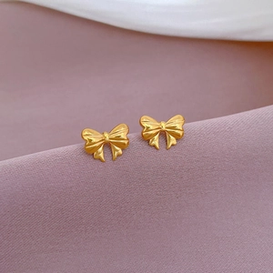 Minimalist golden bow stud earrings in polished stainless steel for a chic fashion look