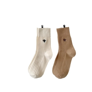 Beige and brown cotton ribbed crew socks featuring bee embroidery on white background